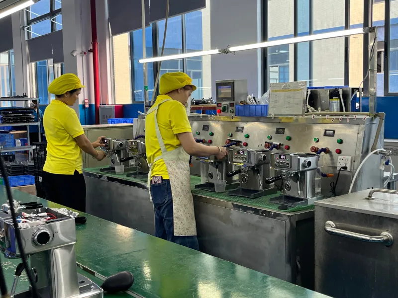 YSELE staff performing final unit inspection on coffee machines before dispatch