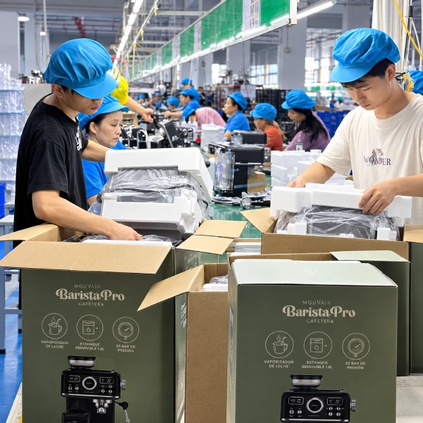 YSELE workers packing coffee machines into protective cartons on the factory production line